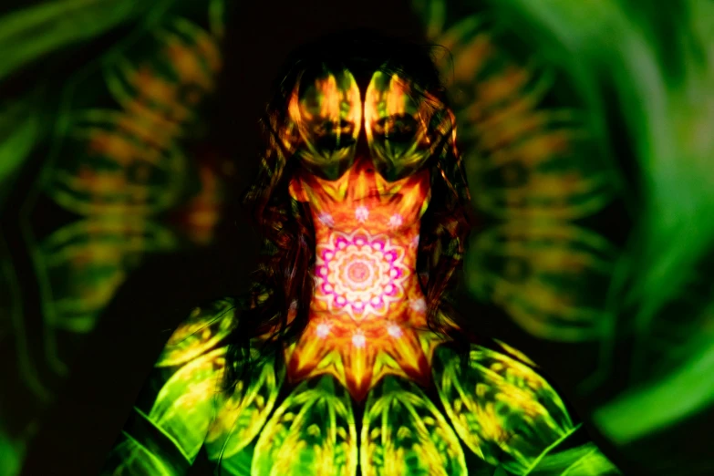 a woman standing in front of a green background, digital art, inspired by Alex Grey, psychedelic art, lensflares, figure meditating close shot, body covers with neon flowers, in the center of the image