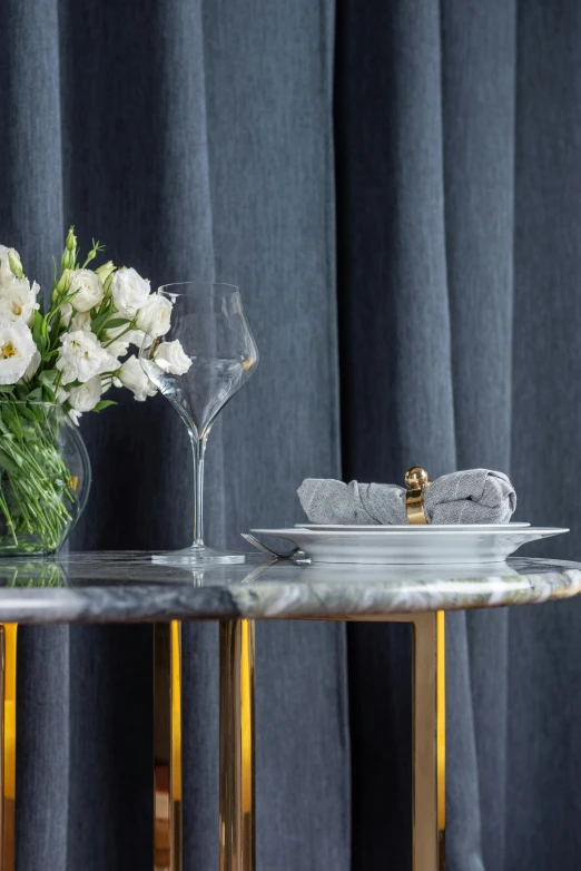 a table with a vase of flowers on top of it, black marble and gold, breakfast, highest quality, fabrics and textiles