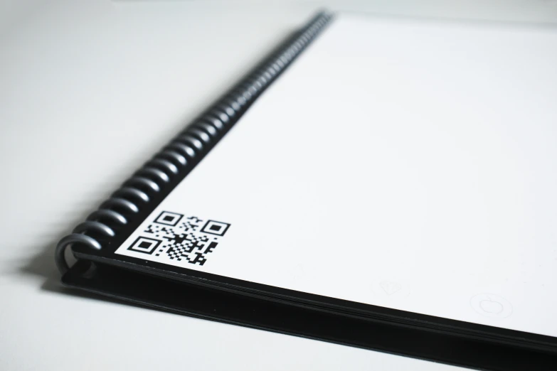 a close up of a notebook with a qr code on it, private press, 9 9 designs, whiteboards, 2022 photograph, no text