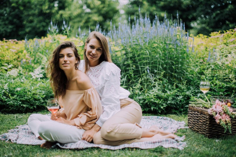 two women sitting on a blanket in a garden, a picture, by Emma Andijewska, pexels, romanticism, portrait image, high quality upload, midsommar - t, lesbian