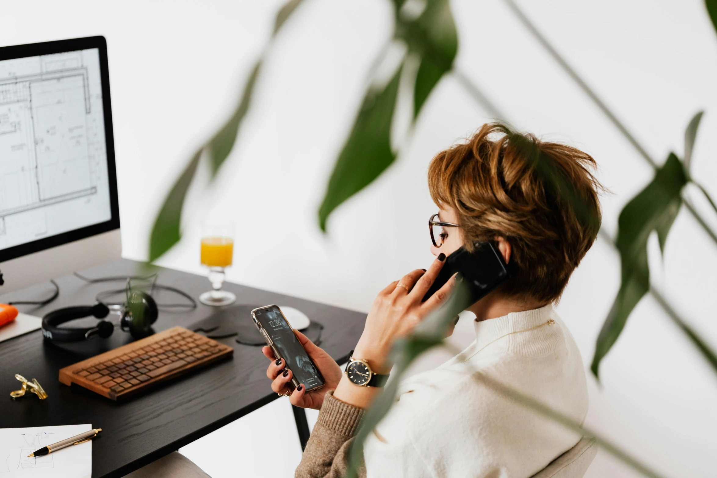 a woman sitting at a desk talking on a cell phone, by Andries Stock, trending on pexels, avatar image, background image, worksafe. instagram photo, from the waist up