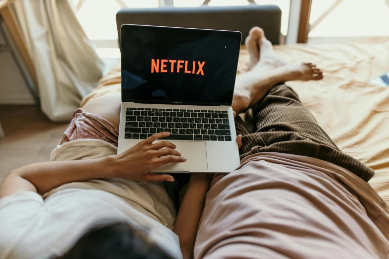 a person laying on a bed with a laptop, trending on pexels, serial art, at netflix, cast, bottom angle, highly technical