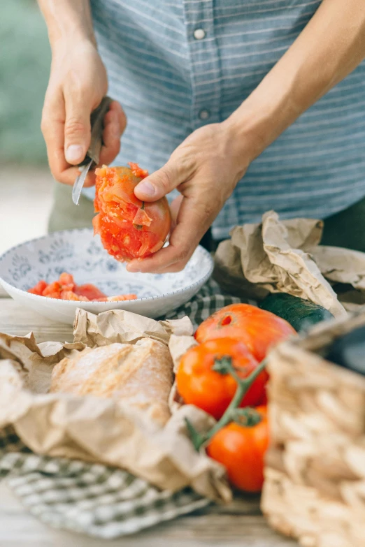 a person putting tomatoes in a bowl on a table, pexels contest winner, having a picnic, man carving himself out of stone, parchment paper, award - winning crisp details ”