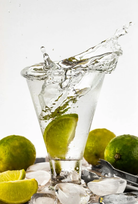 a glass of water with limes and ice, by Ndoc Martini, splashing, promo image, 2995599206