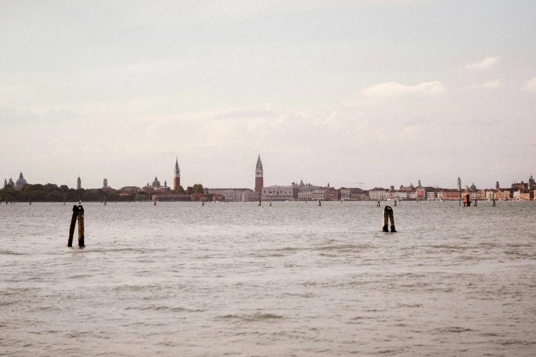 a body of water with a city in the background, olive green and venetian red, leica s photograph, digital image