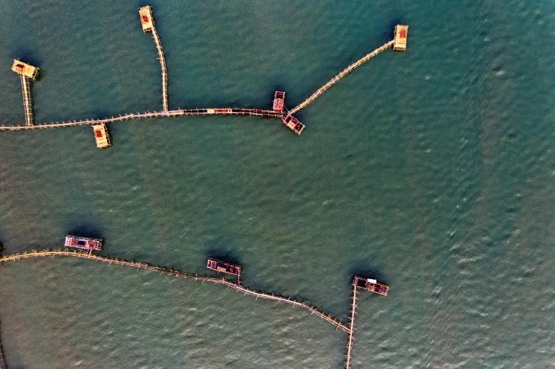 a group of boats floating on top of a body of water, by Attila Meszlenyi, unsplash, conceptual art, cages, satellite imagery, oil rig, 15081959 21121991 01012000 4k