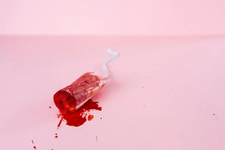 a toothbrush sitting on top of a pink surface, by Rachel Reckitt, pexels contest winner, magic realism, bloody scene, jelly, iv pole, crimson