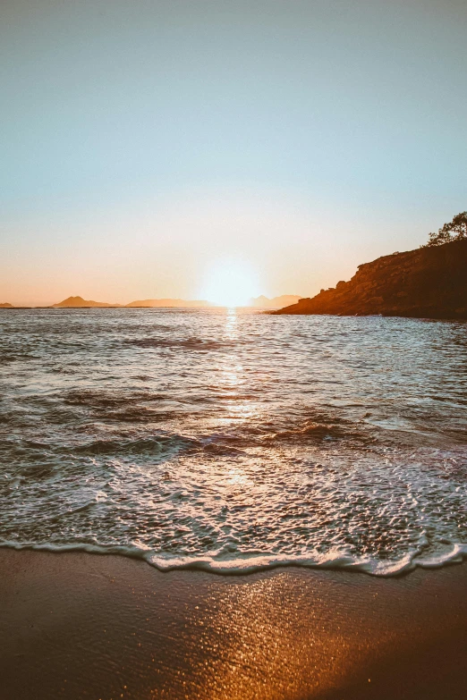 the sun is setting over the water on the beach, by Niko Henrichon, happening, ibiza, 4k serene, stunning screensaver, golden bay new zealand