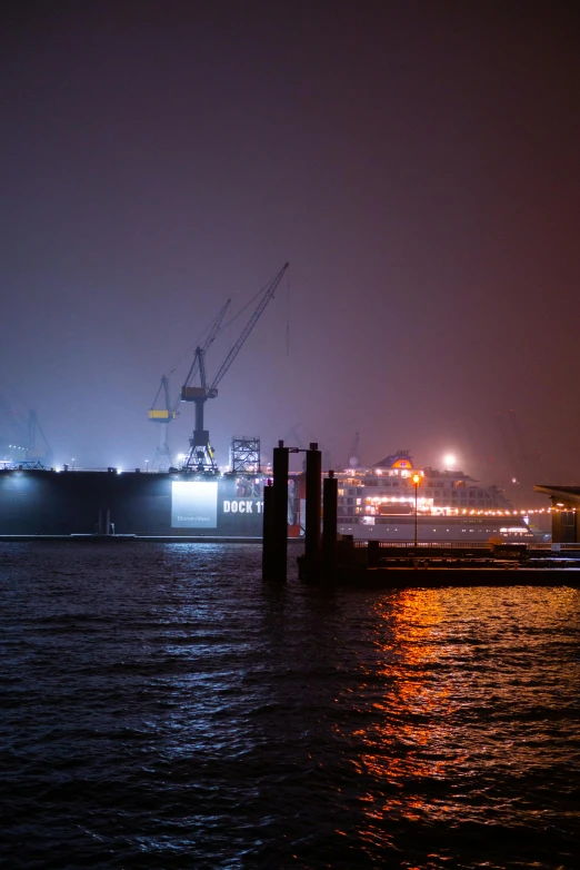 a large ship sitting on top of a body of water, happening, foggy night, cranes, uncropped, slide show