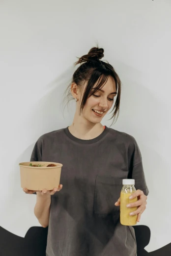a woman holding a cup of orange juice, pexels contest winner, salad, logo for lunch delivery, portrait sophie mudd, kai carpenter