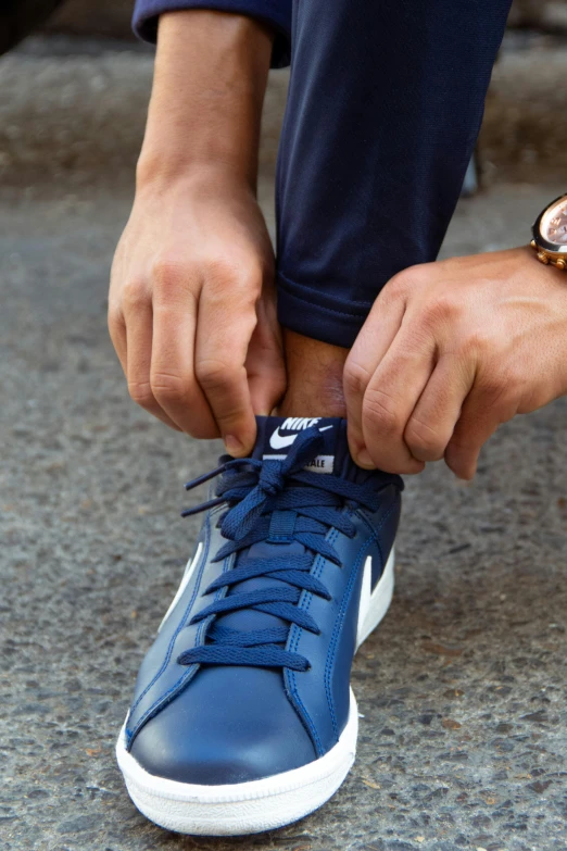 a close up of a person tying up a shoe, kobalt blue, campau mike style, looking confident, navy