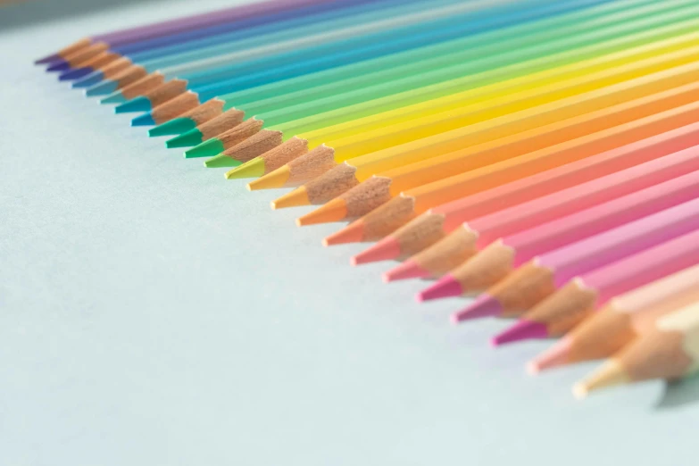 a row of colored pencils sitting on top of a table, by Rachel Reckitt, crayon art, 2 5 6 colours, superfine ink detail, chartreuse and orange and cyan, pastel faded grey rainbow