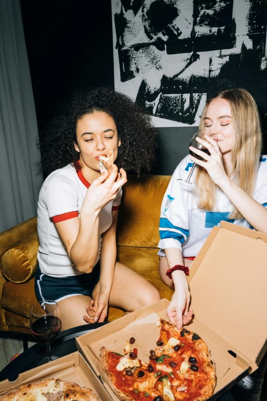 two women sitting on a couch eating pizza, a cartoon, inspired by Nan Goldin, trending on unsplash, cigars, sophie turner girl, college party, 🍸🍋