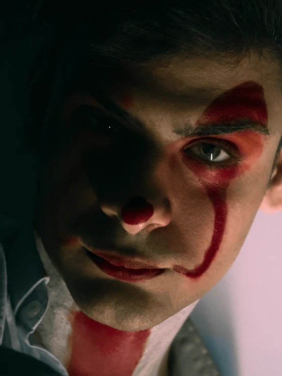 a close up of a man with blood on his face, trending on reddit, serial art, an elf in a suit, declan mckenna, film still promotional image, clowns