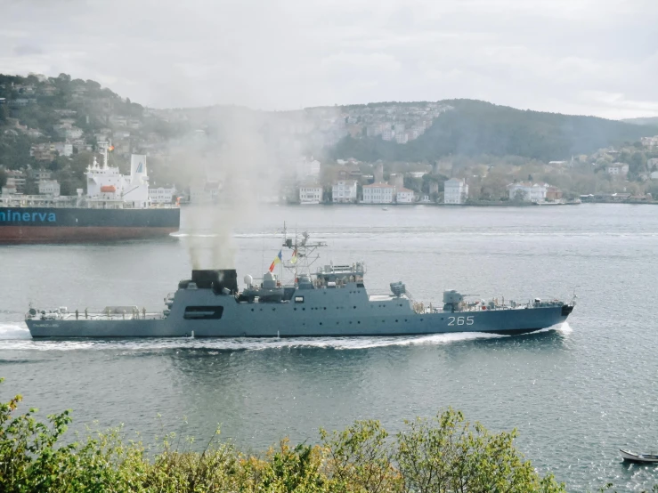 a large boat traveling across a large body of water, by Jens Søndergaard, pexels contest winner, hurufiyya, military parade, launch tracking missiles, seen from outside, thumbnail