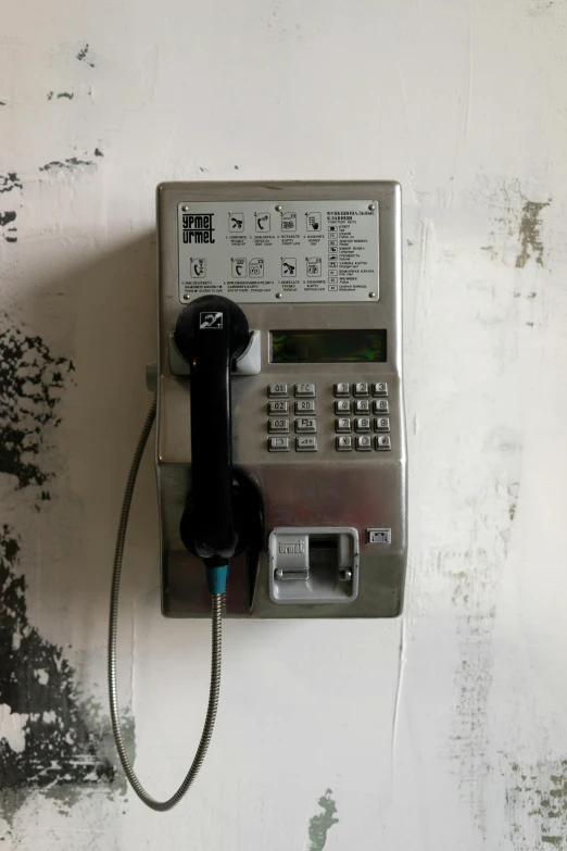 a close up of a telephone on a wall, inspired by Zhang Kechun, graffiti, crypto, 2 0 0 0 s, silo, manual