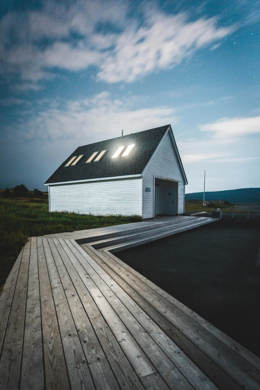 a white house sitting on top of a wooden dock, by Brian Snøddy, pexels contest winner, light and space, church, shed roof, shot on hasselblad, road