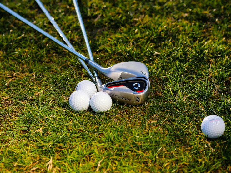 a golf club and golf balls on the grass, by Tom Wänerstrand, pixabay, realism, wide angle dynamic action shot, avatar image, silver, 💋 💄 👠 👗