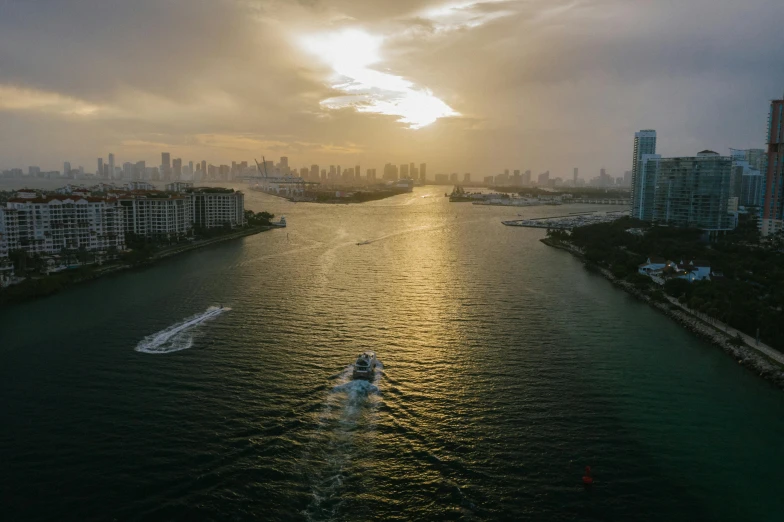 a large body of water surrounded by tall buildings, by Ryan Pancoast, pexels contest winner, happening, vice city, sun lighting from above, on a boat, day setting