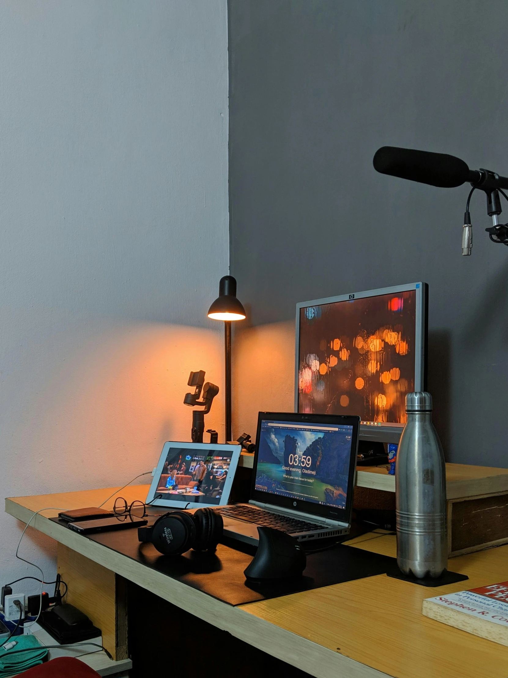 a laptop computer sitting on top of a wooden desk, standing microphones, photograph of 3d ios room, oled lights in corners, ray lighting from top of frame