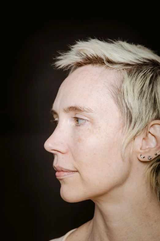 a close up of a person with short hair, beth cavener, androgynous person, right side profile, clear symmetrical face