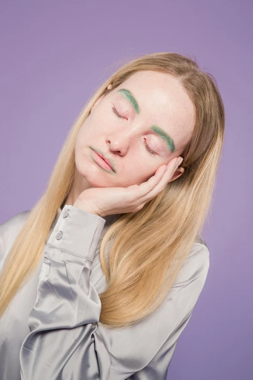 a close up of a person with their eyes closed, inspired by Ren Hang, elle fanning as an android, green and purple studio lighting, hand on cheek, relaxed eyebrows