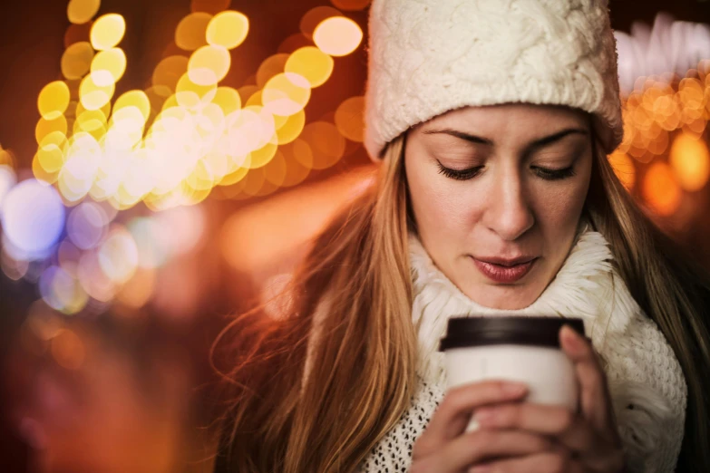 a woman is looking at her cell phone, by Adam Marczyński, trending on pexels, hot cocoa drink, australian winter night, avatar image, gentle bokeh
