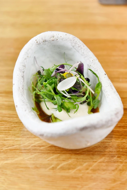 a close up of a small bowl of food on a table, by Jessie Algie, gourmet restaurant, herbs, thumbnail, vanilla