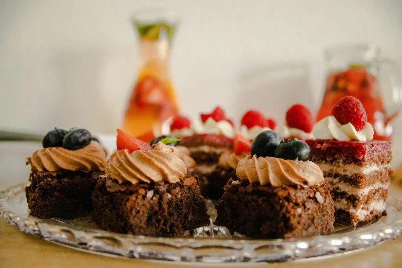 a cake sitting on top of a glass plate, by Adam Marczyński, pexels, eating cakes, brown red blue, plates of fruit, chocolate frosting