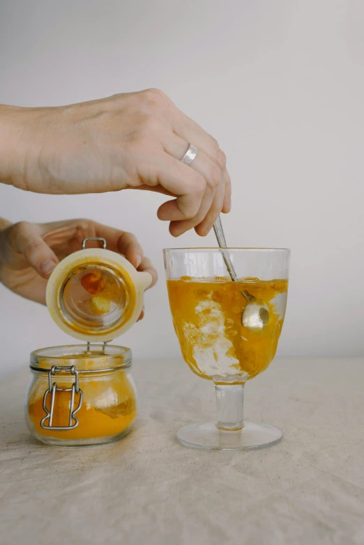 a person pouring orange juice into a glass, inspired by Wlodzimierz Tetmajer, seafood in preserved in ice, easy to use, marmalade, thumbnail