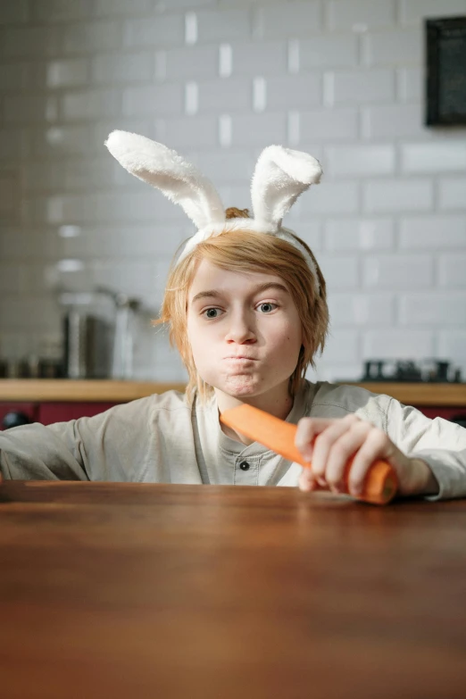 a girl sitting at a table with a carrot in her hand, pexels contest winner, pointy bunny ears, annoyed, boys, cooking show