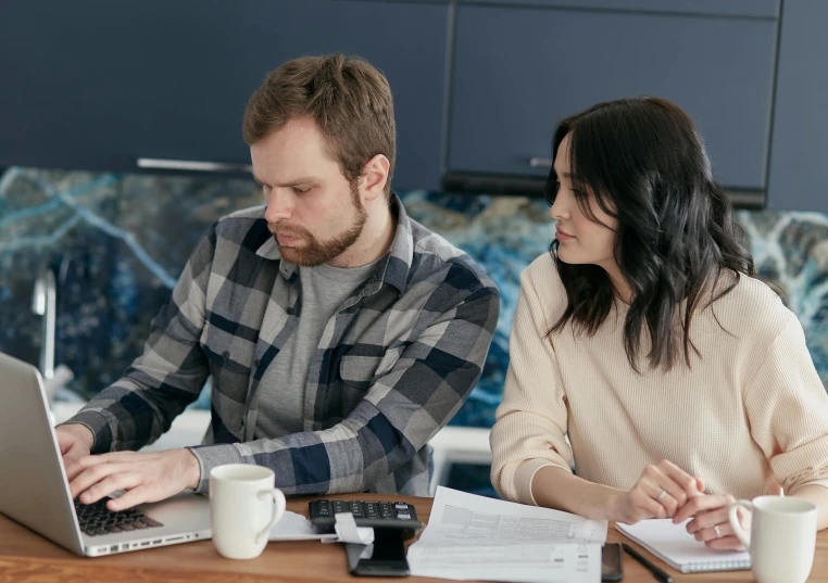 a couple of people sitting at a table with a laptop, profile image, te pae, looking serious, maintenance