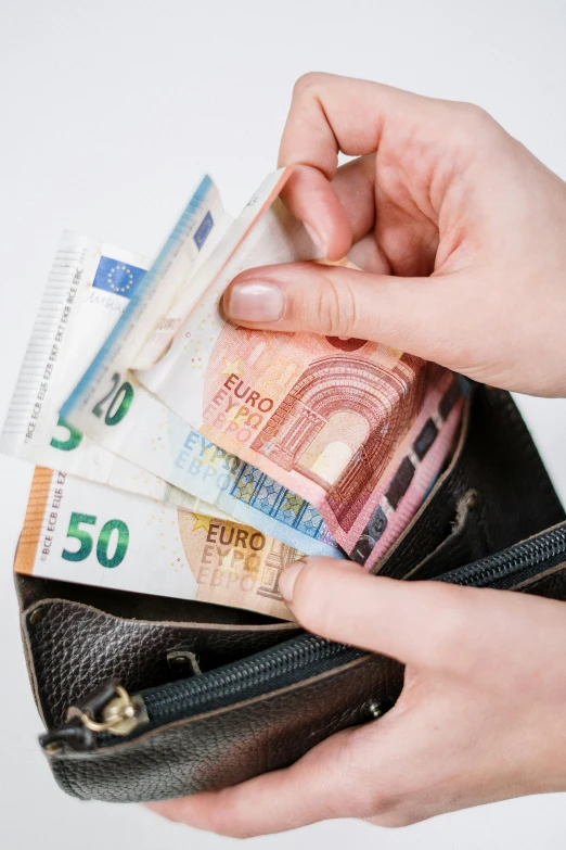 a person holding a wallet full of money, by Matija Jama, square, europe, stockphoto, filmstill