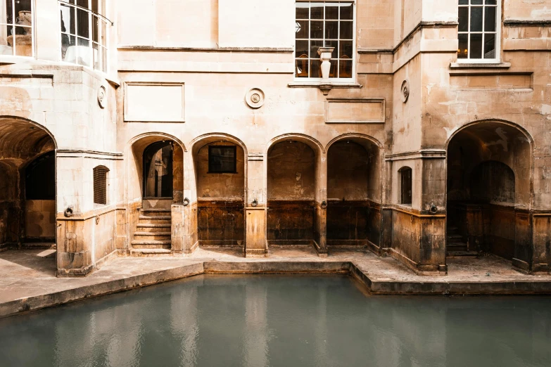 a building with a pool in the middle of it, a photo, by Julia Pishtar, unsplash contest winner, renaissance, bath, well preserved, mason, taken in the early 2020s