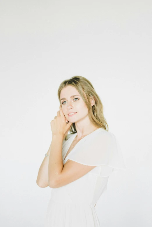 a woman in a white dress posing for a picture, an album cover, by Sara Saftleven, happening, clear background, britt marling style, lovingly looking at camera, without text