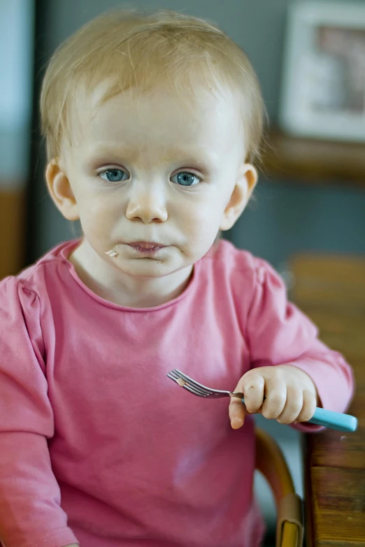 a little girl sitting at a table with a fork in her hand, wide neck, titanium, promo image, enamel