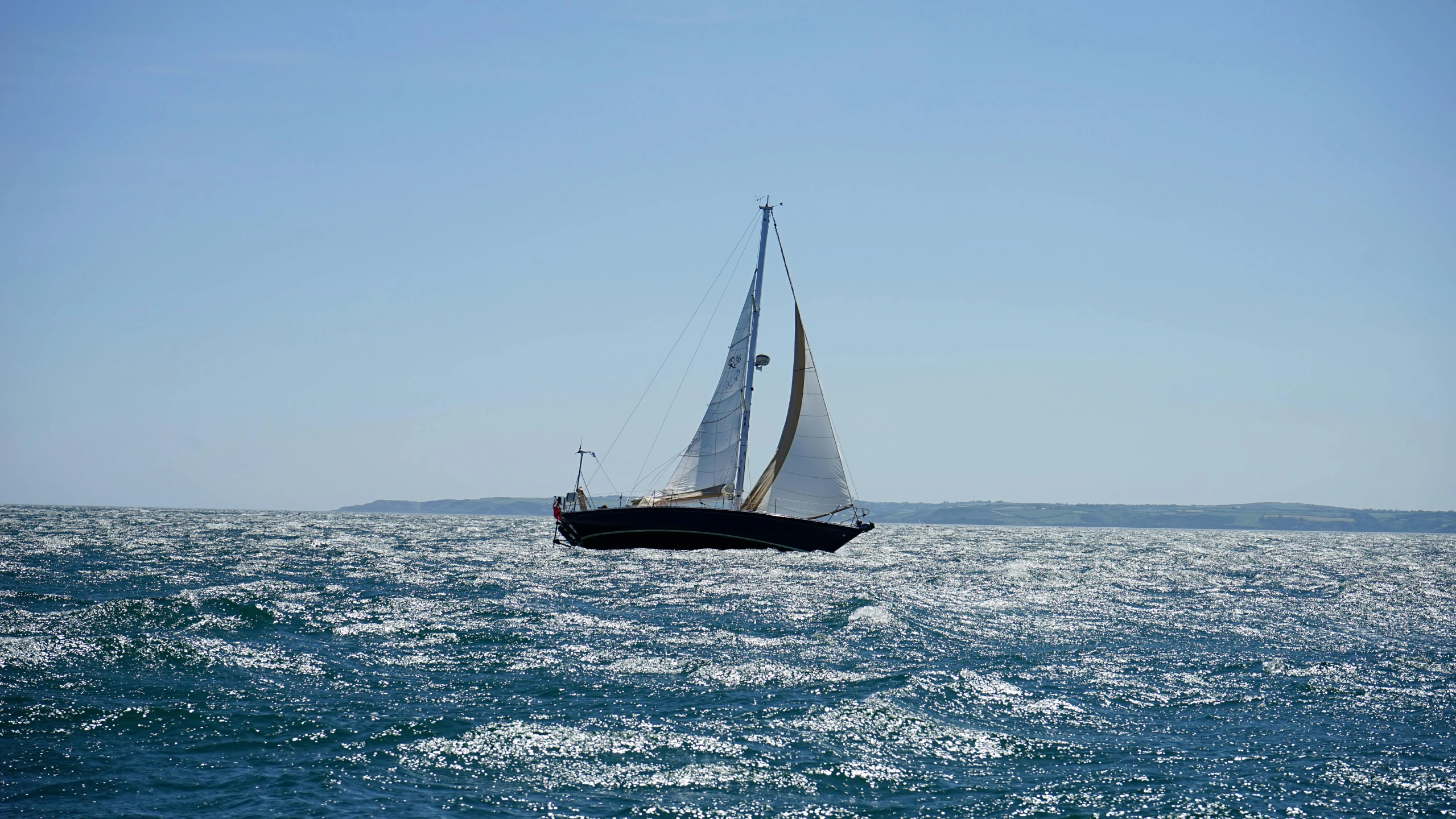 a sailboat in the middle of a large body of water, a picture, pixabay contest winner, figuration libre, high winds, side profile shot, slightly sunny weather, ignant