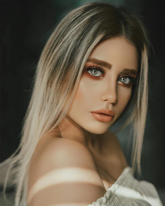 a woman with long blonde hair posing for a picture, a colorized photo, inspired by Elsa Bleda, trending on pexels, her skin is light brown, grey contacts, she has olive brown skin, non binary model