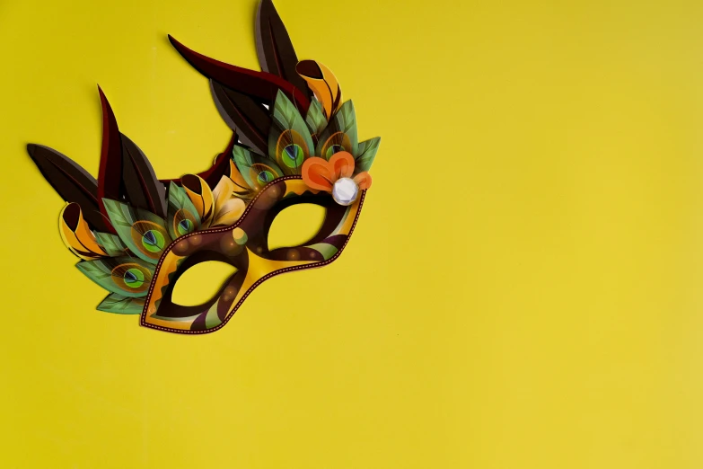 a close up of a mask on a yellow background, inspired by Bernd Fasching, trending on pexels, fruit and feathers, majestic pose, realistic fantasy, product design shot