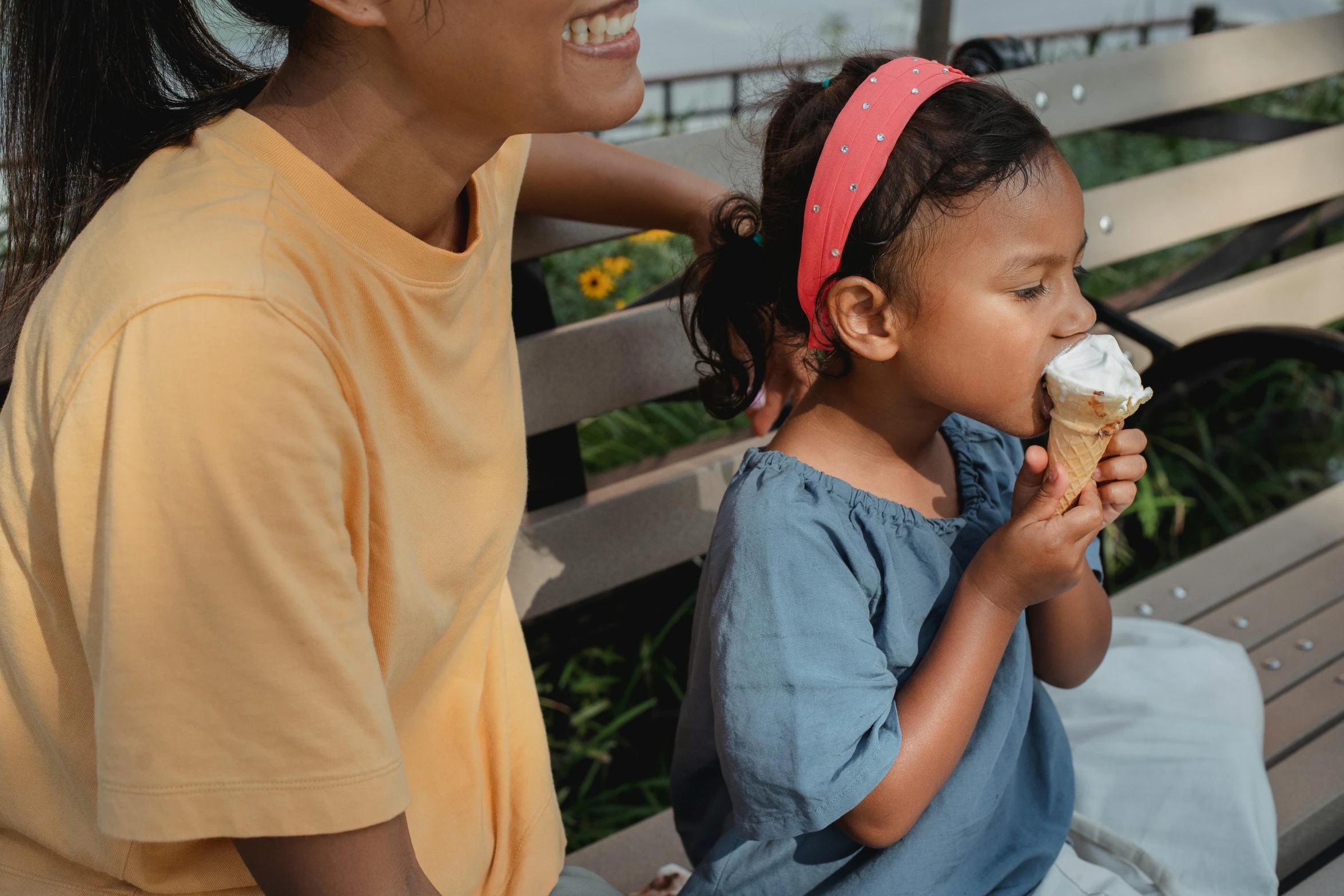 a woman sitting next to a little girl eating an ice cream cone, pexels contest winner, avatar image, 1 5 0 4, picnic, caramel