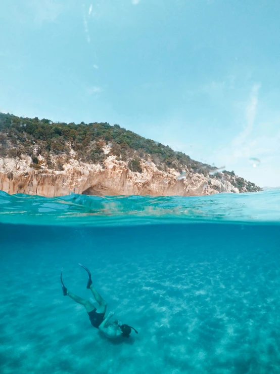 a person swimming in the ocean with a surfboard, capri coast, bubbly underwater scenery, profile image, multiple stories