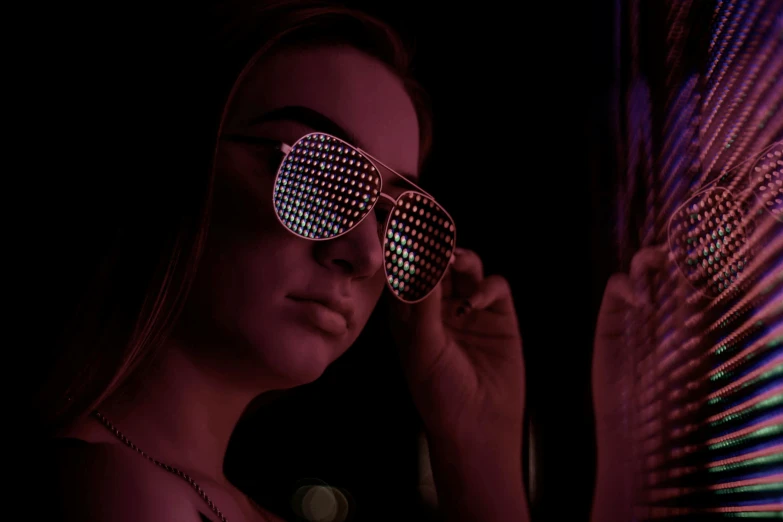 a close up of a person wearing sunglasses, inspired by Elsa Bleda, trending on pexels, holography, night club, bisexual lighting, looking towards camera, intricated