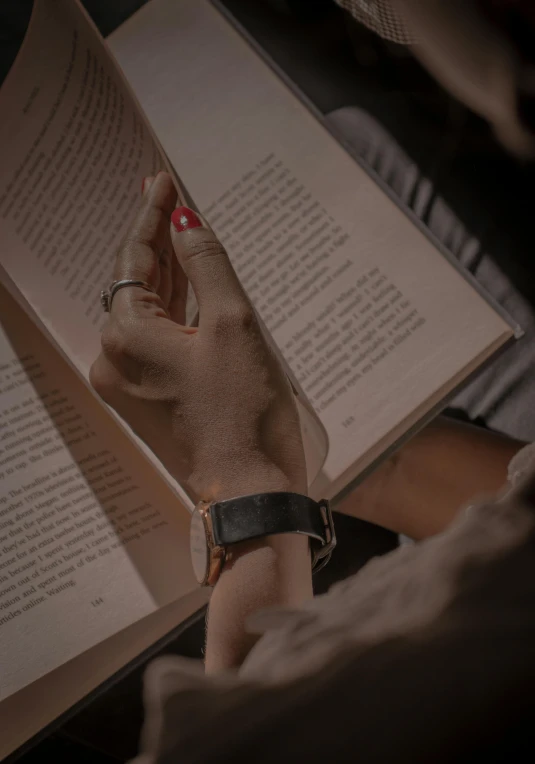 a close up of a person reading a book, sleek hands, faved watched read, profile image