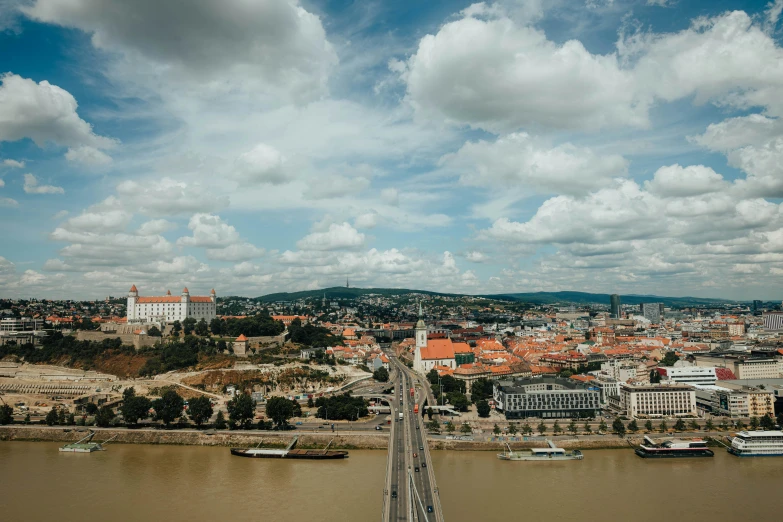 a bridge over a large body of water, by Tobias Stimmer, pexels contest winner, viennese actionism, white buildings with red roofs, 4 k cinematic panoramic view, brown, square