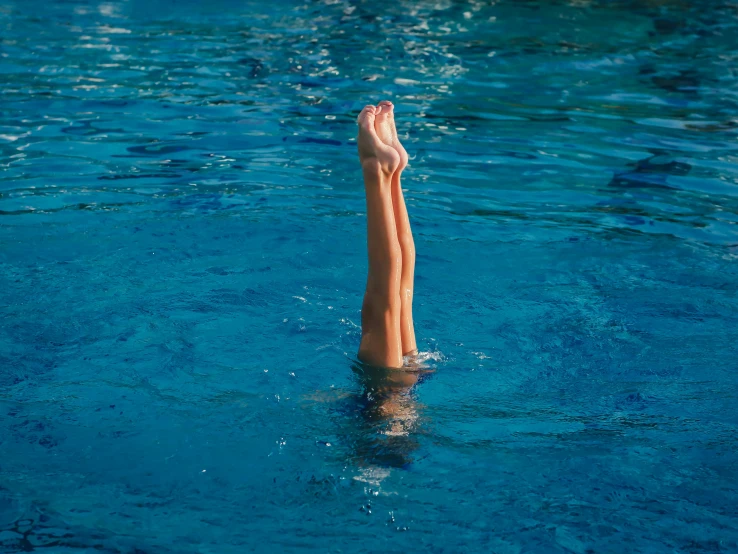 a close up of a person swimming in a pool, pexels, arabesque, hanging upside down, standing on two legs, blue, thumbnail