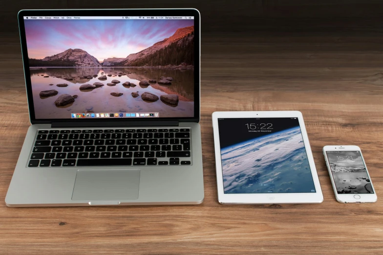 a laptop computer sitting on top of a wooden table, pexels, 9 9 designs, laptops, josh grover, ipad pro