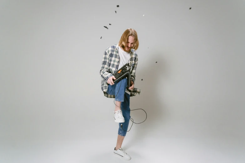 a woman holding a tennis racquet in one hand and a tennis racket in the other, an album cover, unsplash, graffiti, wearing a plaid shirt, studio shoot, firing laser rifle, jamie campbell bower