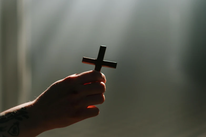 a person holding a cross in their hand, pexels, rays, instagram post, 15081959 21121991 01012000 4k, devils