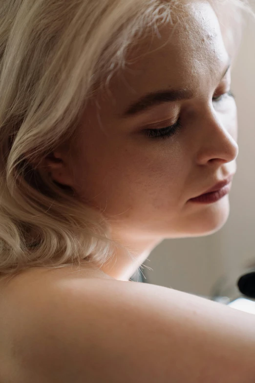 a woman sitting on top of a bed next to a window, close up of a blonde woman, pianist, neck zoomed in, film still promotional image