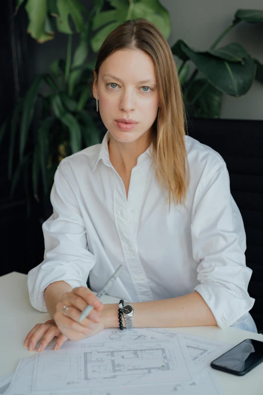 a woman in a white shirt sitting at a table, dasha taran, wearing business casual dress, alex kanevsky, photograph taken in 2 0 2 0